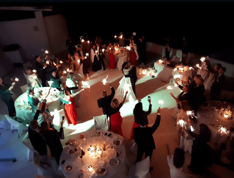 SPARKLERS AT THE ROCABELLA VENUE - WEDDING IN SANTORINI , Destination Wedding in Santorini | Hire a Wedding Dj | wedding Fireworks